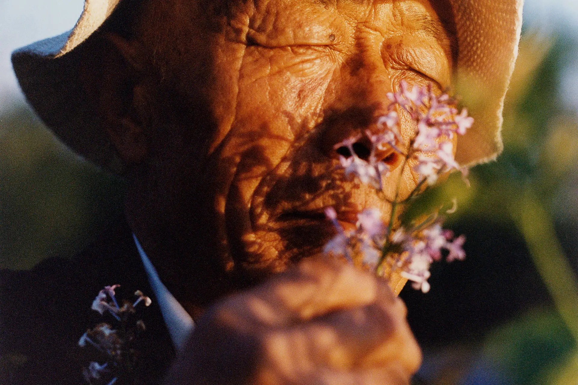 Senior smelling flower